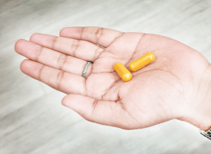 pills on woman hand